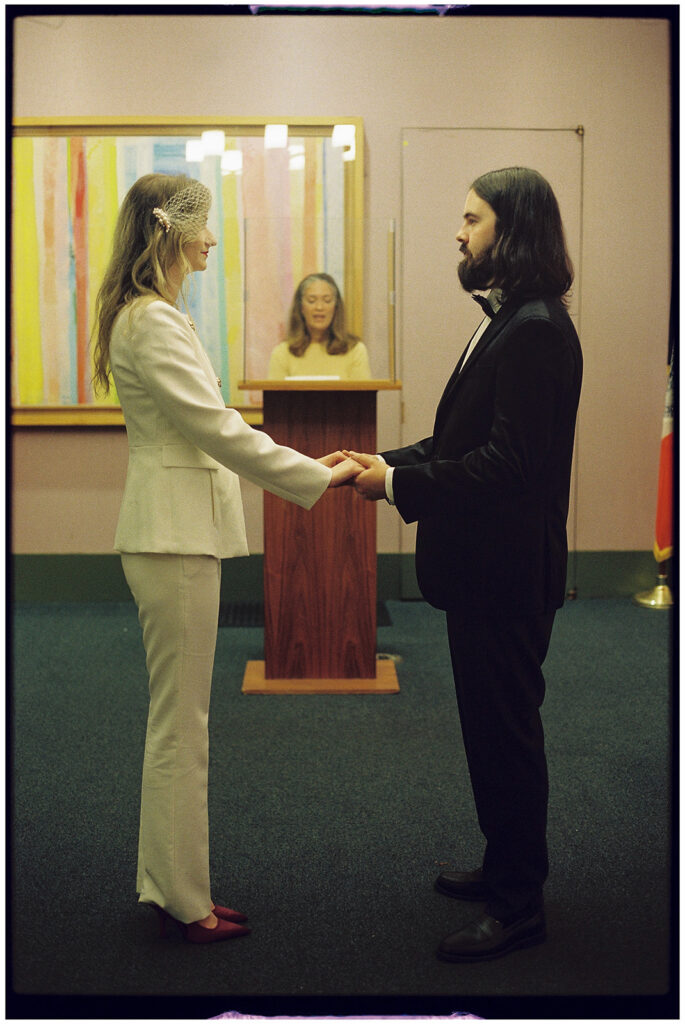Film wedding photographer captures cinematic New York elopement at City Clerk’s Office, minimal and romantic ceremony.