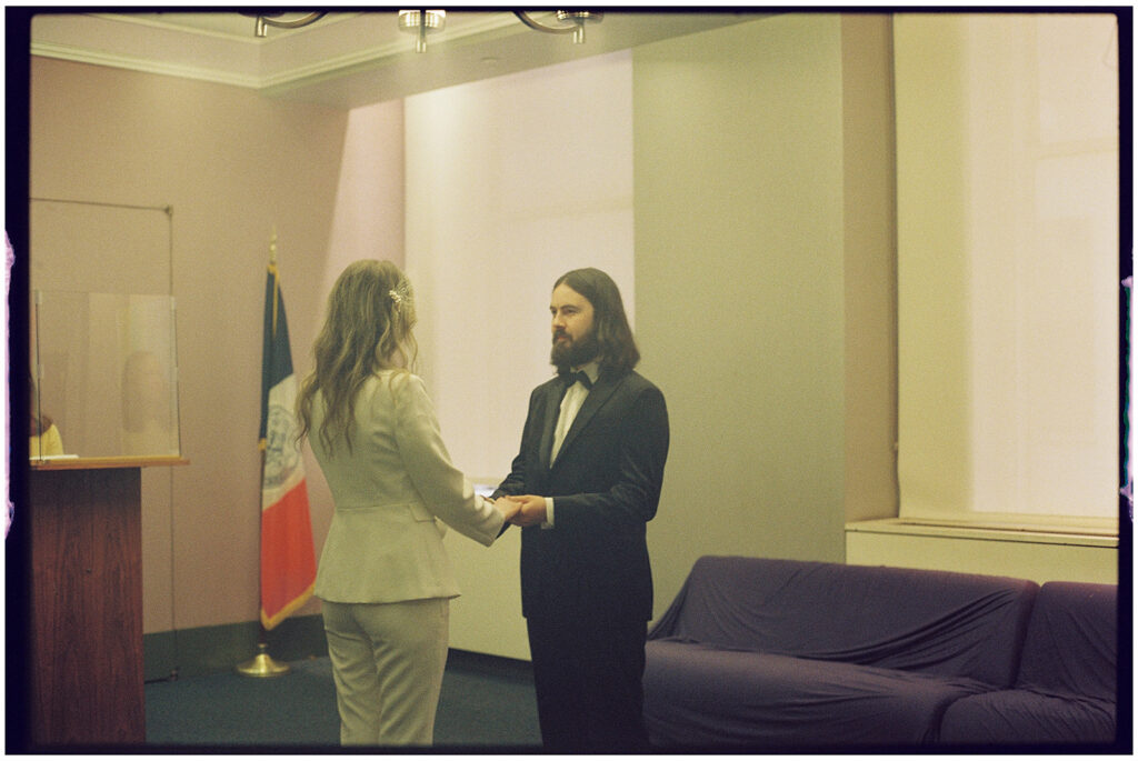 Film wedding photographer captures cinematic New York elopement at City Clerk’s Office, minimal and romantic ceremony.