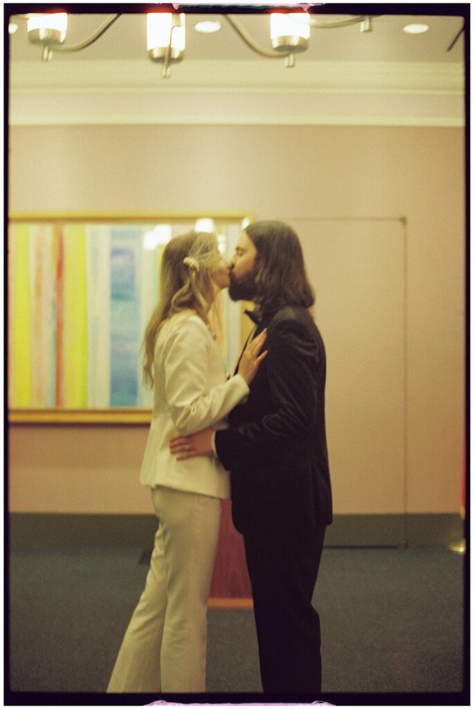 Film wedding photographer captures cinematic New York elopement at City Clerk’s Office, minimal and romantic ceremony.