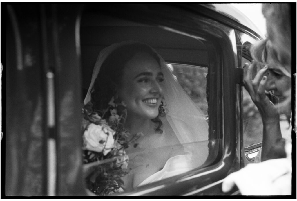 Bride in vintage car shot on 35mm film photography