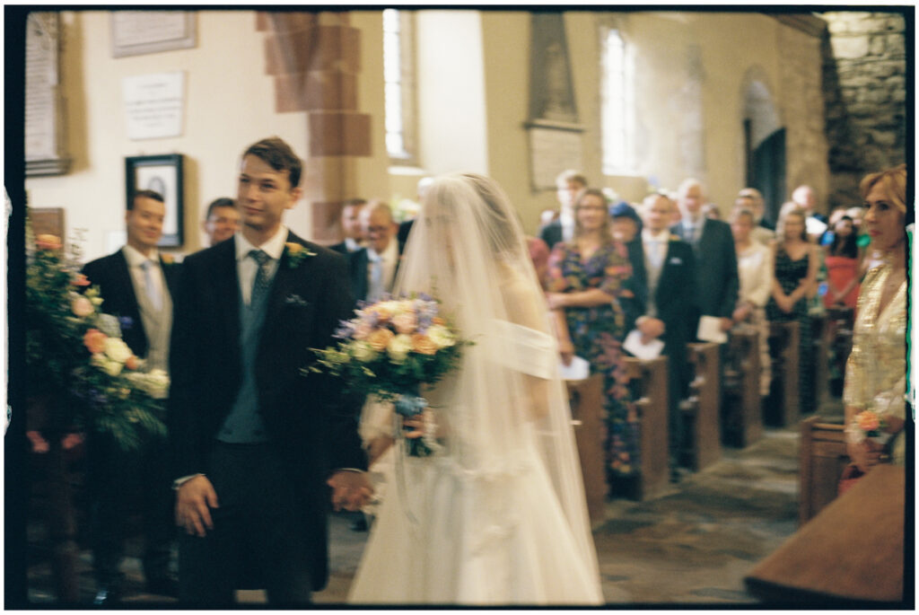 Couple getting married in a Church in Shropshire shot on 35mm film photography 