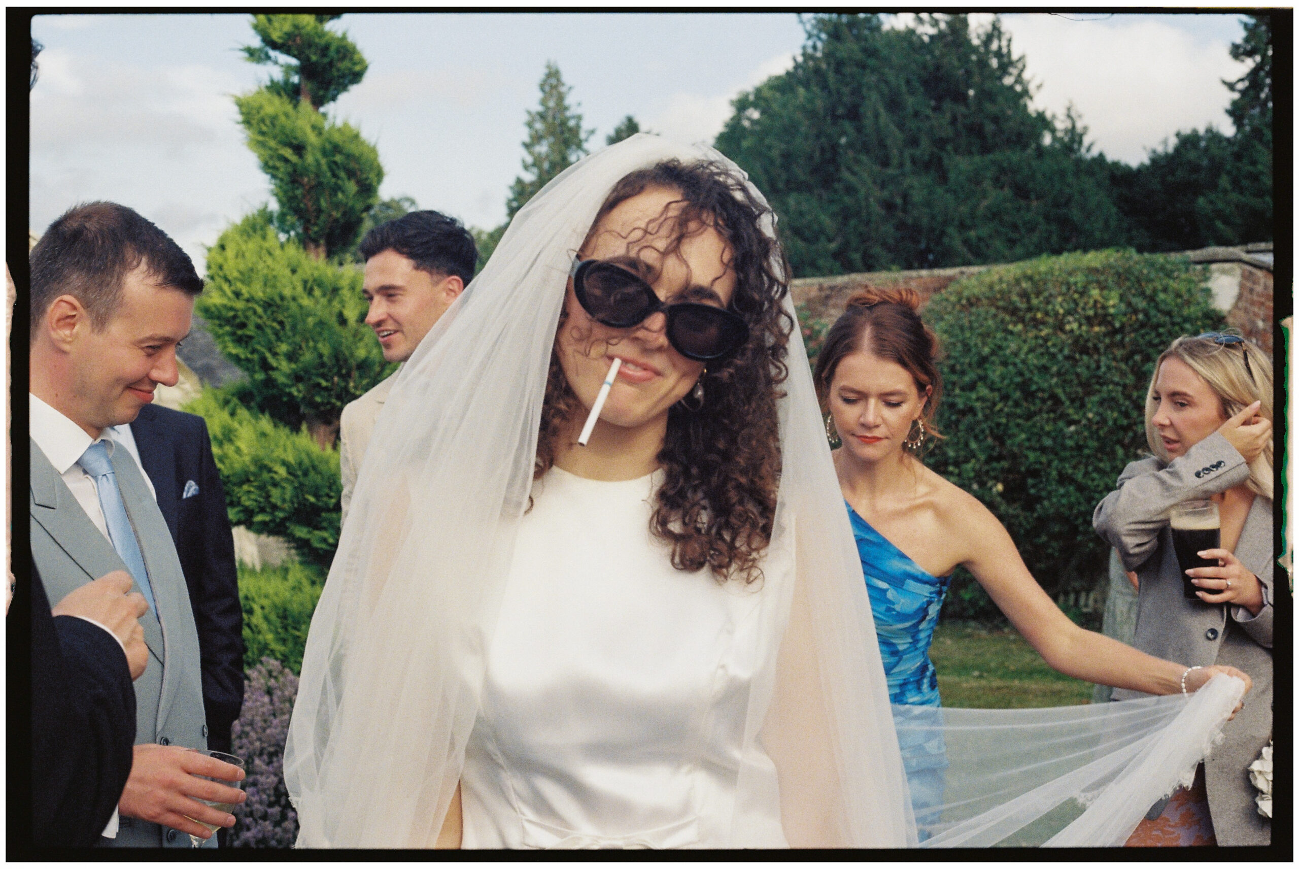 Bride Smoking in vintage wedding dress shot on 35mm film
