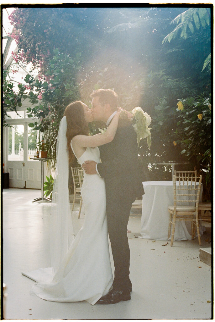 Bride & Groom kissing at the Palm House, Liverpool captured on 35mm film 